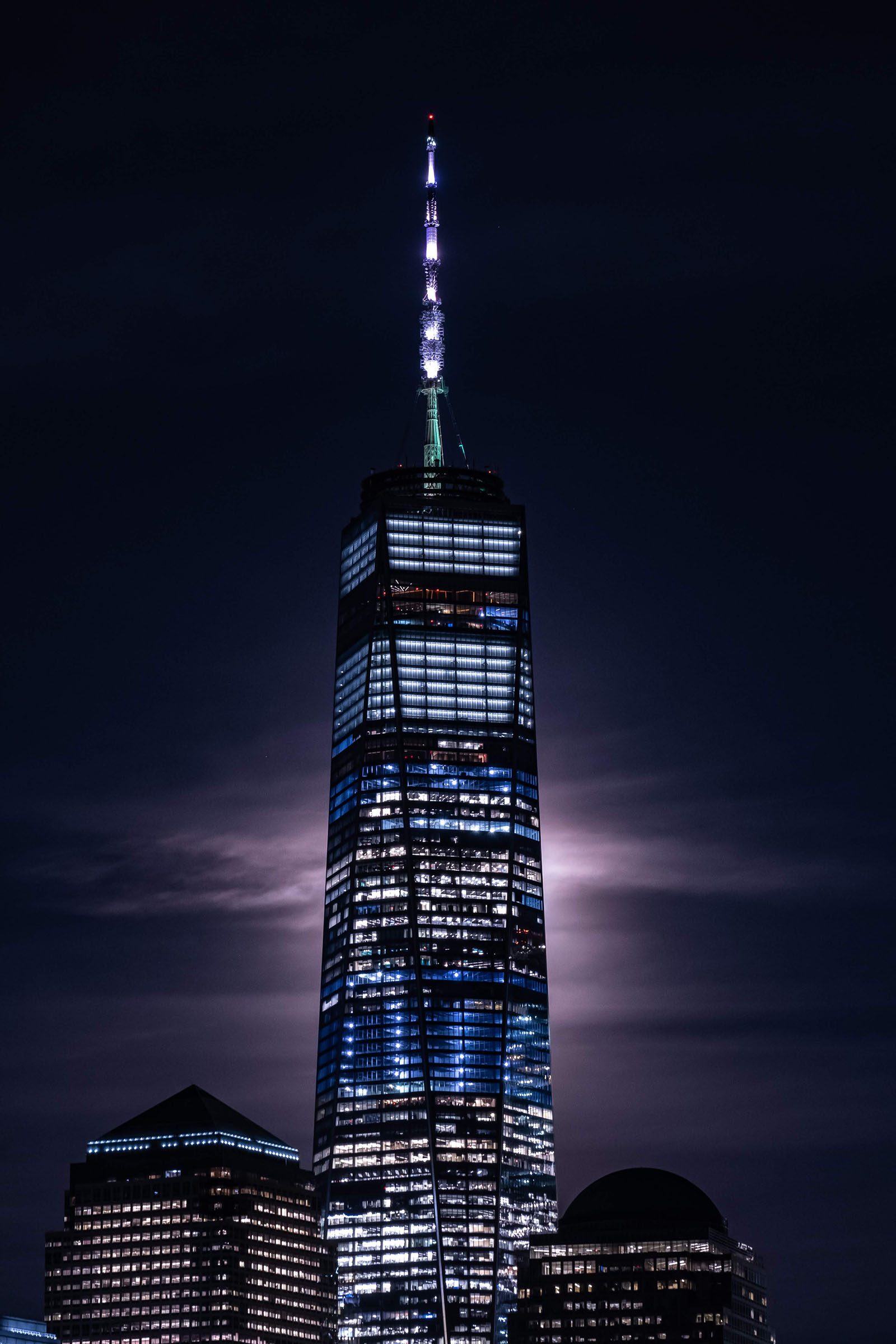 The moon passing behind the One World Trade Center